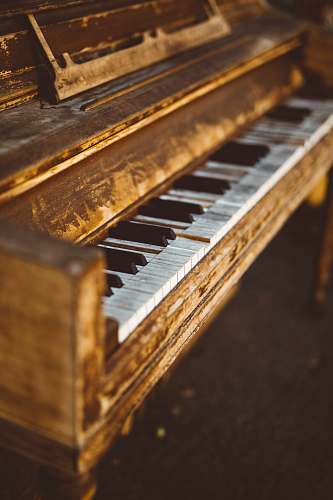 music selective focus photogrpahy of brown wooden console piano musical instrument